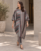 Vayra by House of Somarra — Walking view of the loose striped tunic and trousers.