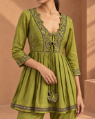 Madhavi by House of Somarra — Close-up of the ornate neckline, waist ties and green fabric.