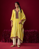 Amara by House of Somarra — Full-length view of the yellow kaftan and ivory trousers.