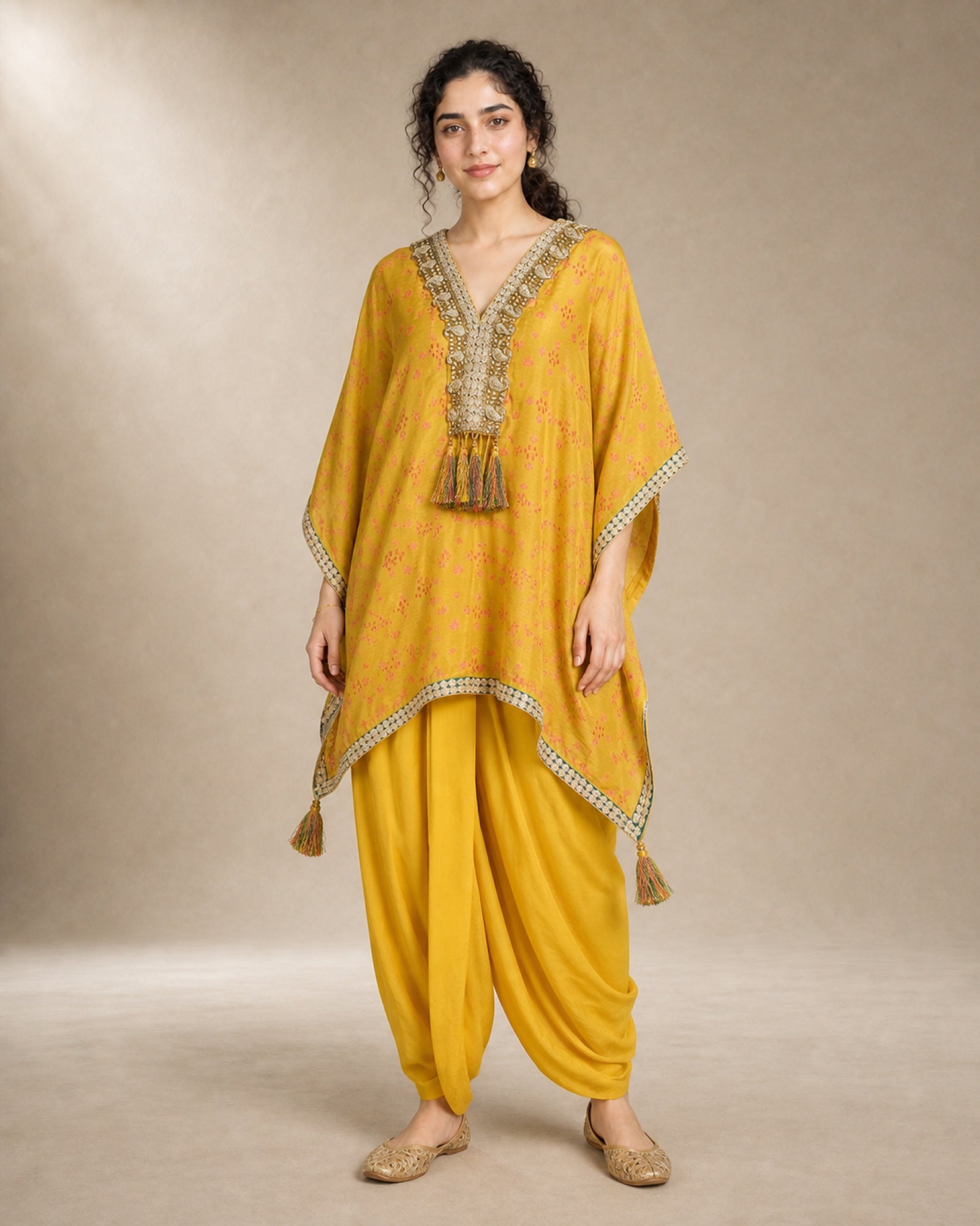 Sunehri yellow tie-dye Chanderi silk kaftan with hand-embroidered zari and stone front yoke, tassels and soft mul-cotton cowled dhoti, front view