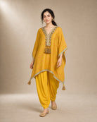 Three-quarter walking view of the Sunehri yellow tie-dye kaftan and soft mul-cotton cowled dhoti