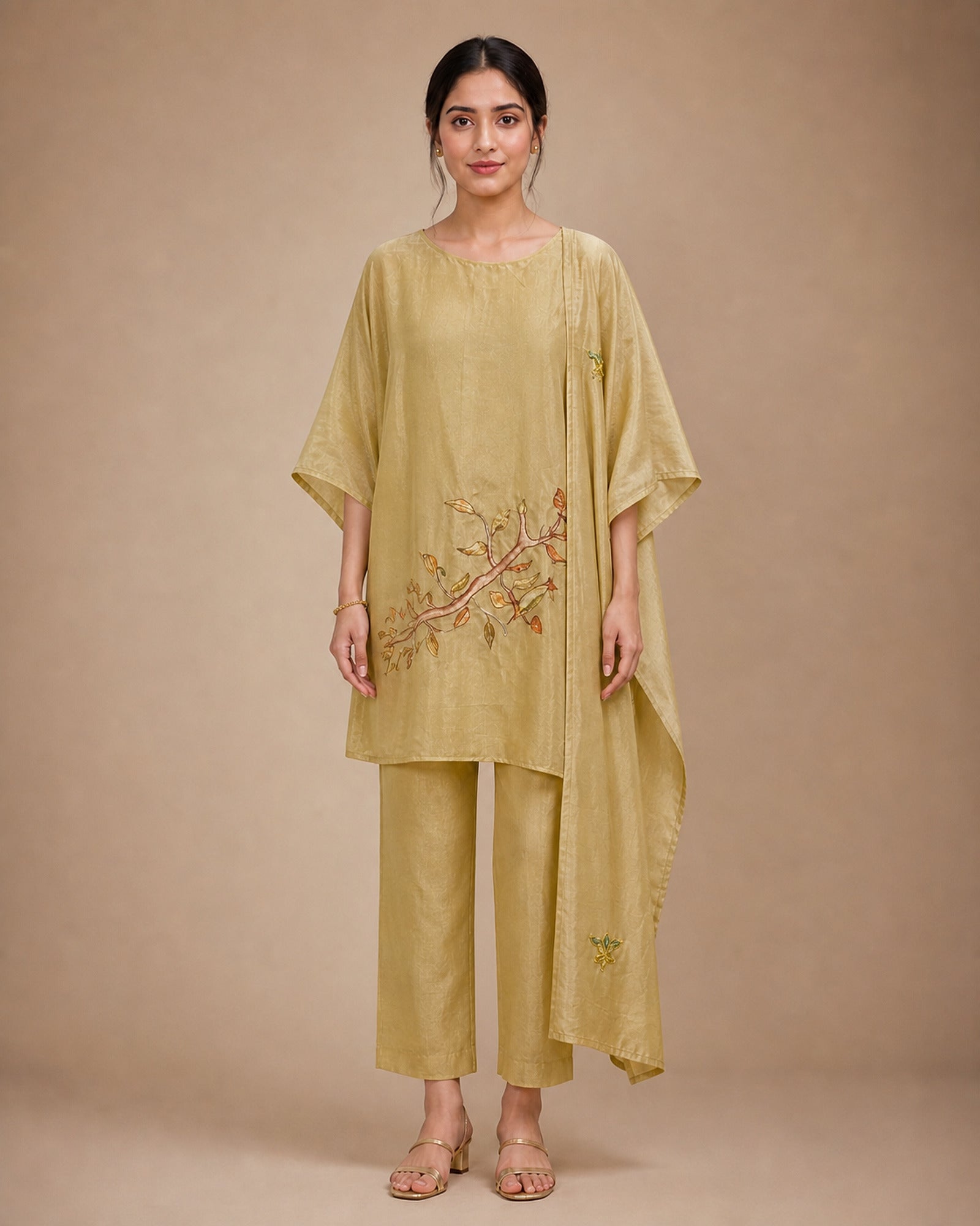 Front view of the Taru solder-beige Chanderi-material co-ord suit with a wide round neckline, draped sleeves, lower-front branch-and-leaf appliqué, narrow bottom and stole