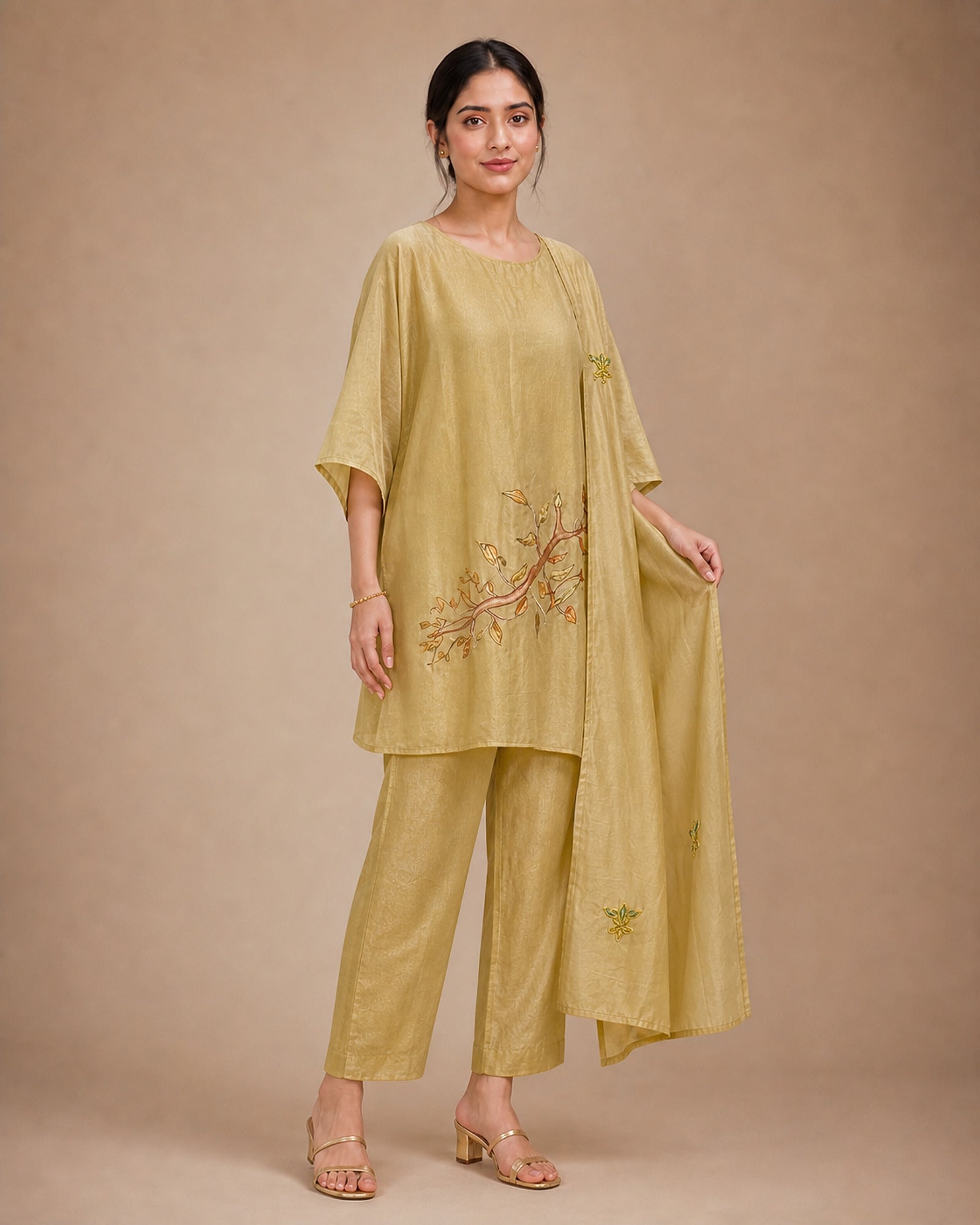 Three-quarter view of the Taru solder-beige Chanderi-material co-ord suit, showing the draped upper, narrow bottom and stole