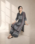 Tirya: Black, White & Red Striped Co-ord Suit – seated three-quarter