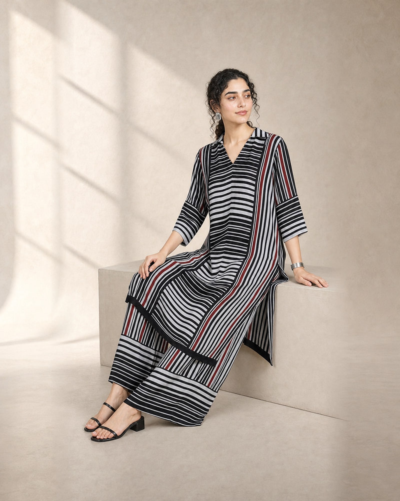 Tirya: Black, White & Red Striped Co-ord Suit – seated three-quarter