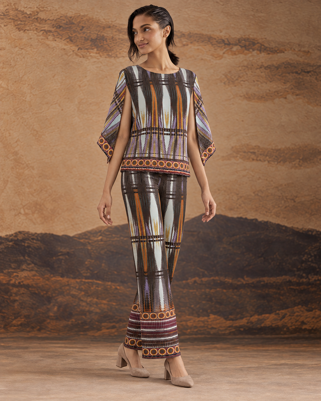 Aroha by House of Somarra — Walking view of the geometric top and flared trousers.