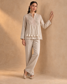 Noorika by House of Somarra — Walking view showing the softly flared sleeves and waist tassels.