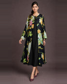 Front-side view of the Vanika black botanical-print front-open midi dress, with its button front and black coverage inner visible