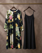 Hanger packshot of the Vanika botanical-print modal-satin front-open midi dress with its separate plain black modal-satin inner
