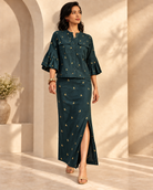 Vihaga by House of Somarra — Walking view of the green tunic and skirt ensemble.