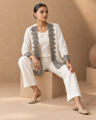 Aaina by House of Somarra — Seated view showing the matching trousers and embellished jacket.