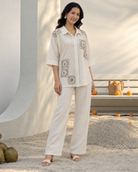 Mihira by House of Somarra — Front view of the cream shirt and trousers with square crochet-style motifs.