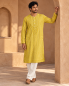 Zarva mustard-yellow striped kurta set — full-length view with cream pyjamas.